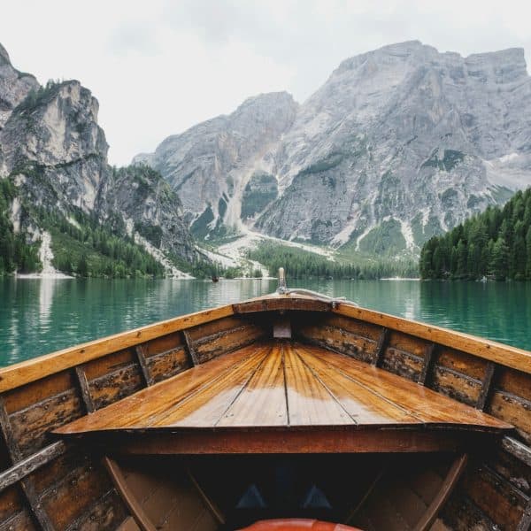 A view from a boat on a river surrounded by mountains