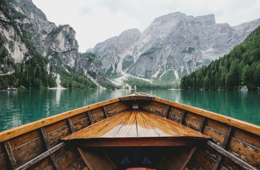 A view from a boat on a river surrounded by mountains