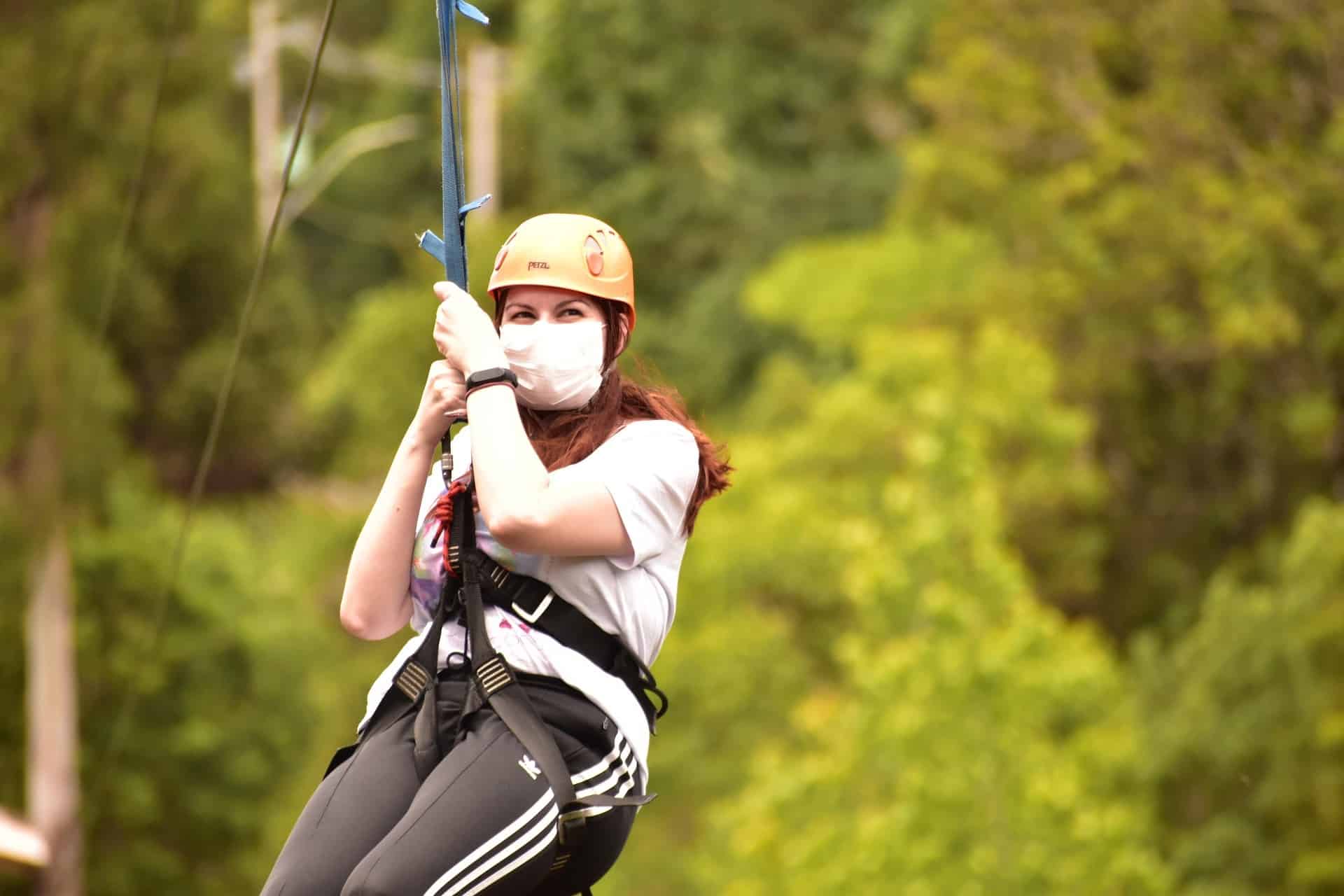 A woman is ziplining through the Arenal Rainforest