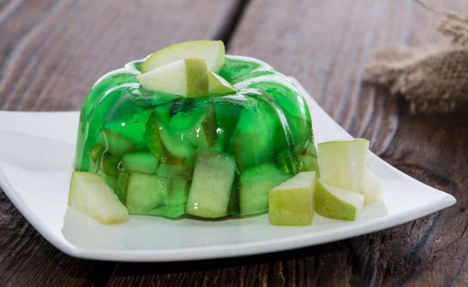 Image of a round Jell-O molded in a bundt shape with apples