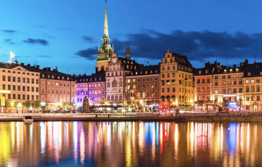 Image of a city in Sweden on a river with bright lights