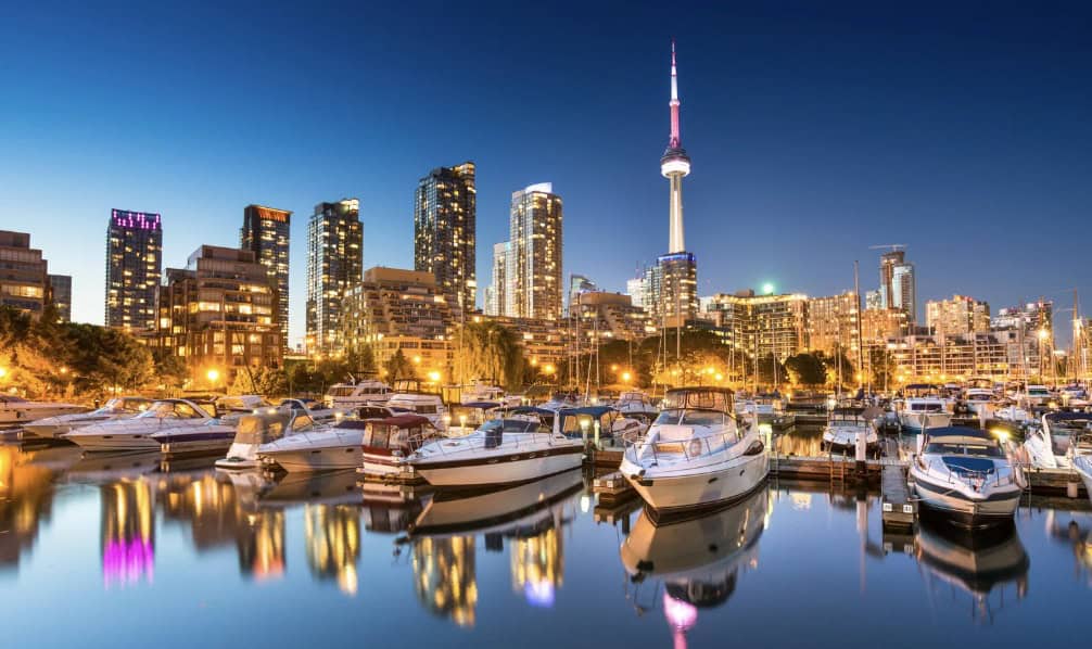 Skyline of the city of Toronto at night reflected in water