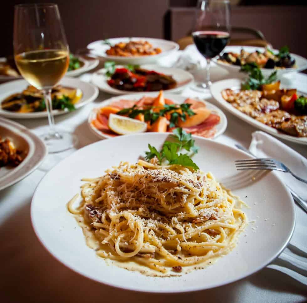 Bruna's Ristorante dishes arranged on a table with glasses of wine
