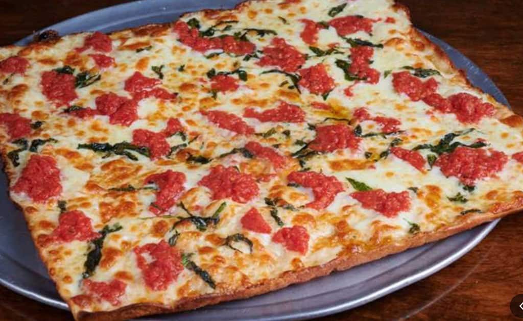 Umberto's Pizza with cheese, basil, and red sauce